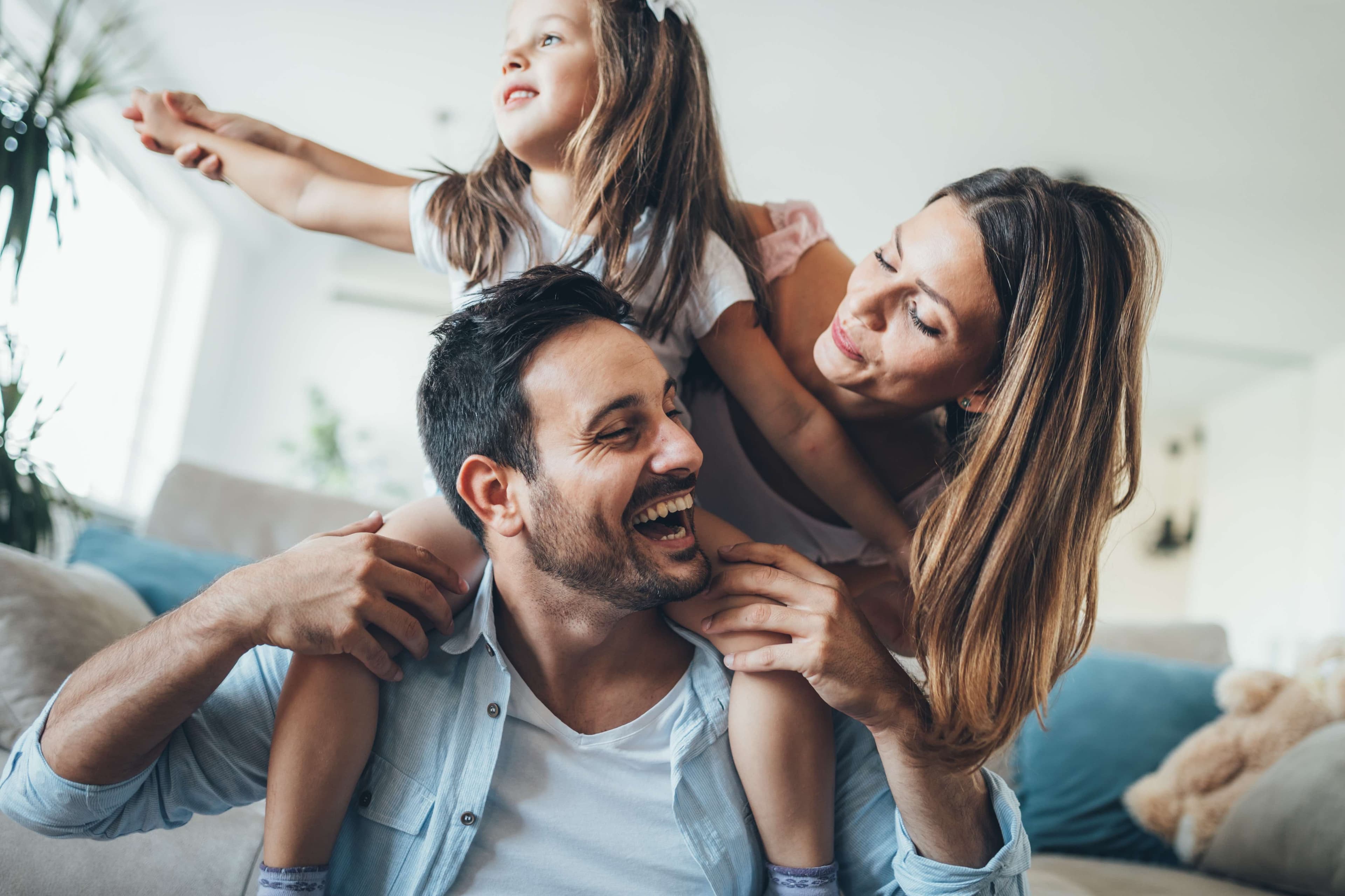 Italian parents with daughter on dad's shoulders